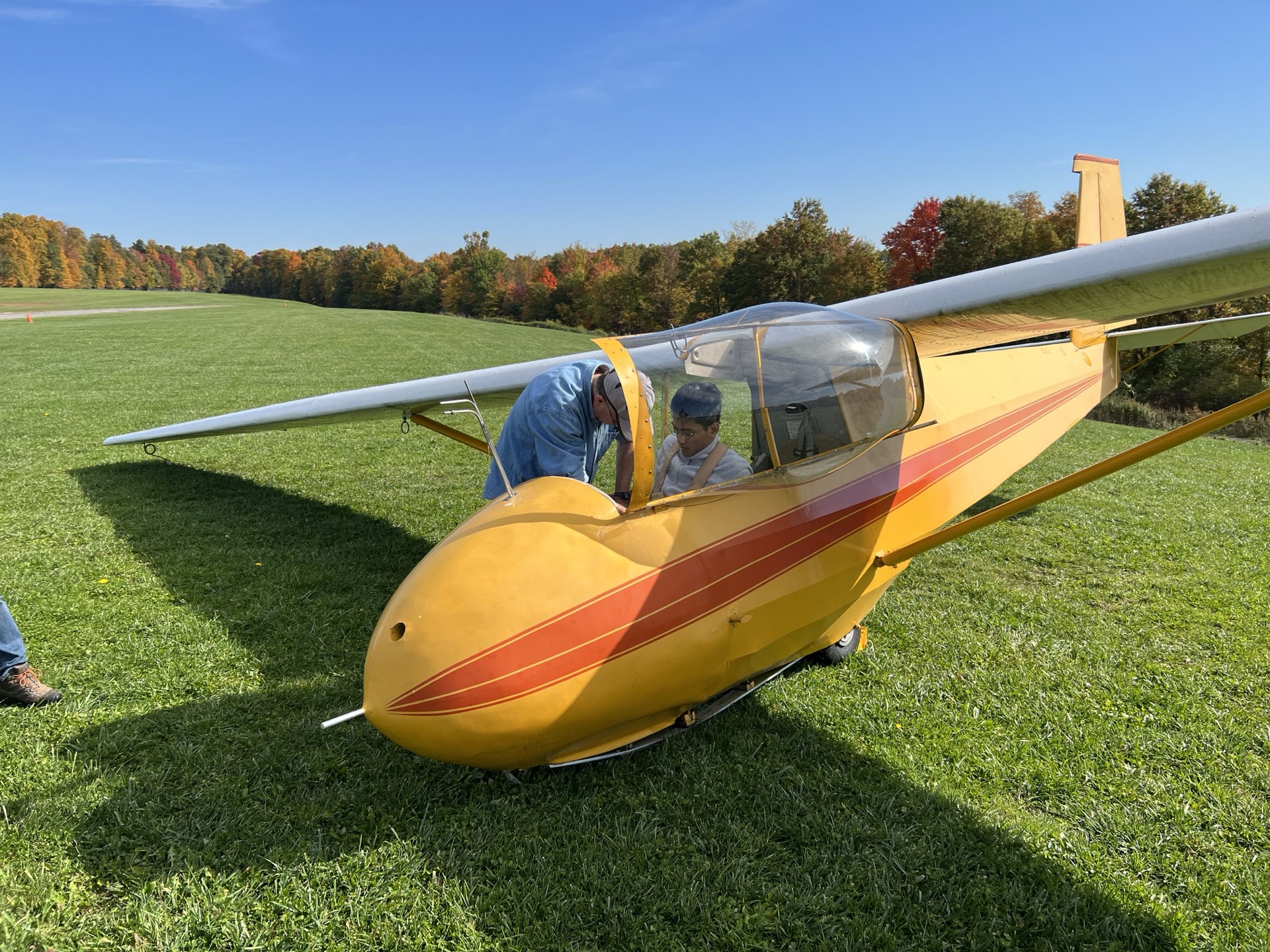 Club member standing next to an airplane